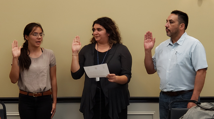 Ana Karen Estrada (far left) and Oswaldo Estrada (far right) being sworn in
