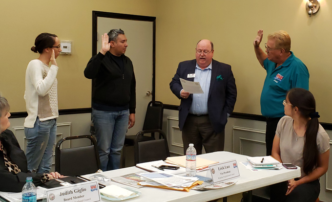 Jill Kline (far left), Franklin Solis (2nd to left) and Erick Lace (far right, standing) being sworn in as Assistant Parliamentarian, Parliamentarian and Vice President